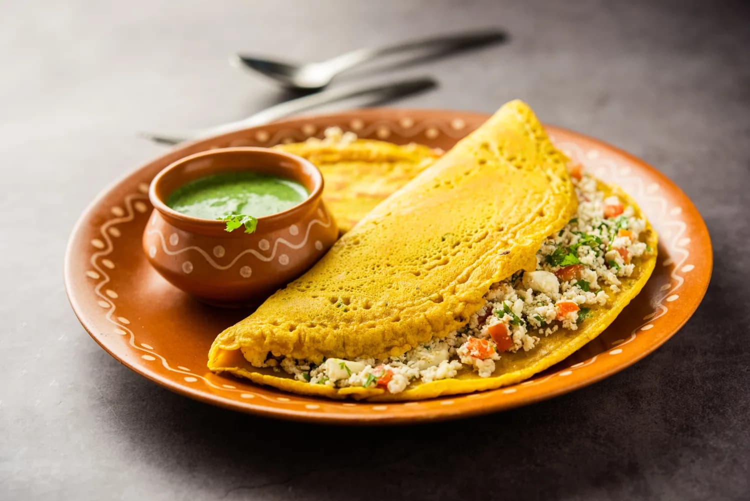 Paneer stuffed cheela served with fresh green chutney
